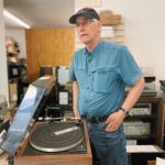 Loyal Lawrence, founder of Audio Service Inc., works on a vintage turntable.