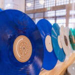 Image of vinyl records in shades of blue, white, green, and orange.