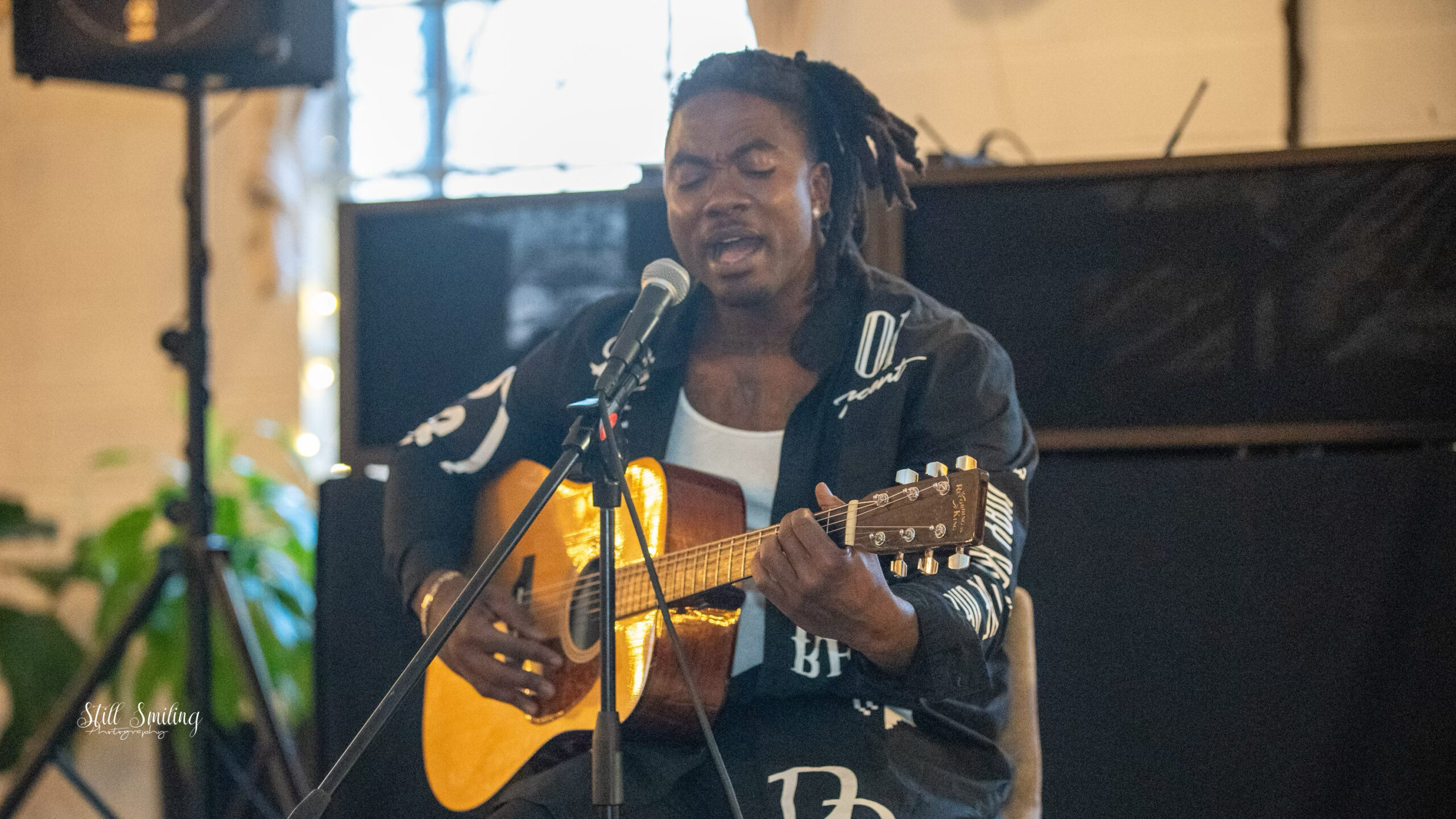 R&b / rap artist Gully Mills playing an acoustic guitar